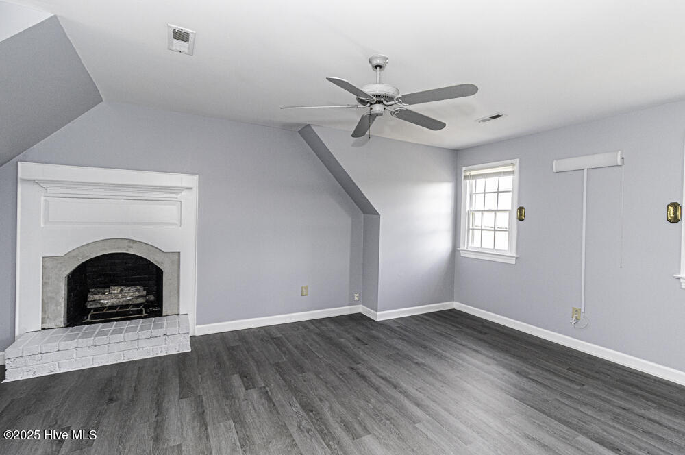 849 Jeffreys Road Rocky Mount, NC 27804 - Photo 11 of 26 New laminate wood flooring and cozy fireplace!