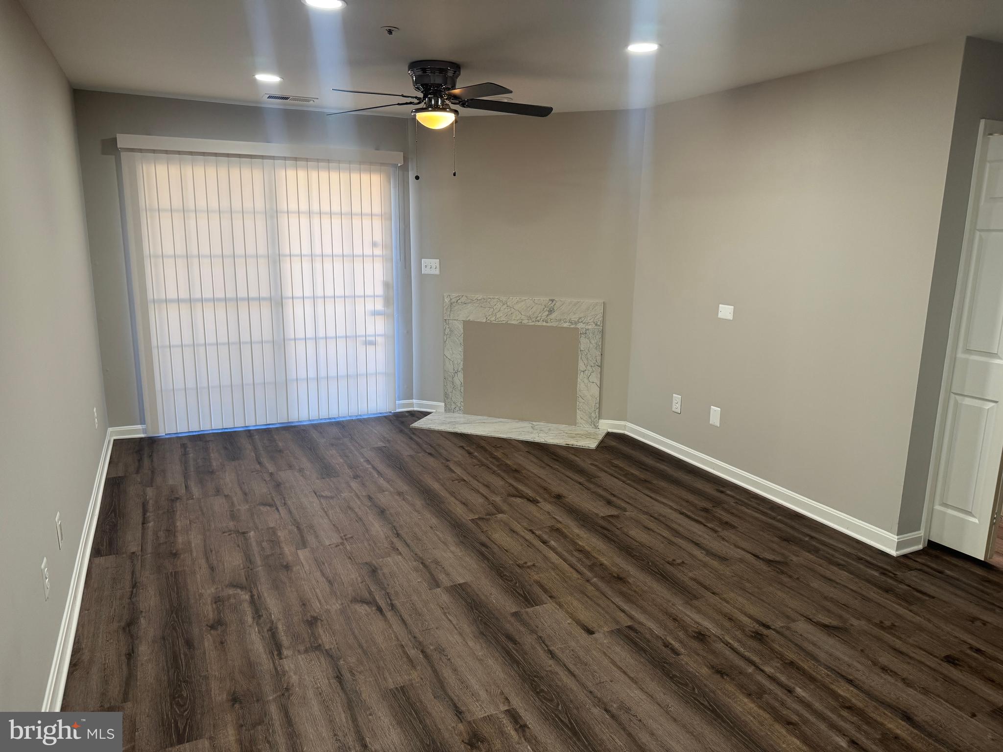 11263 Raging Brook Drive, Unit 253 Bowie, MD 20720 - Photo 7 of 22 an empty room with wooden floor and windows