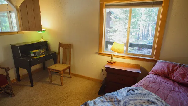 a bedroom with a bed and a window