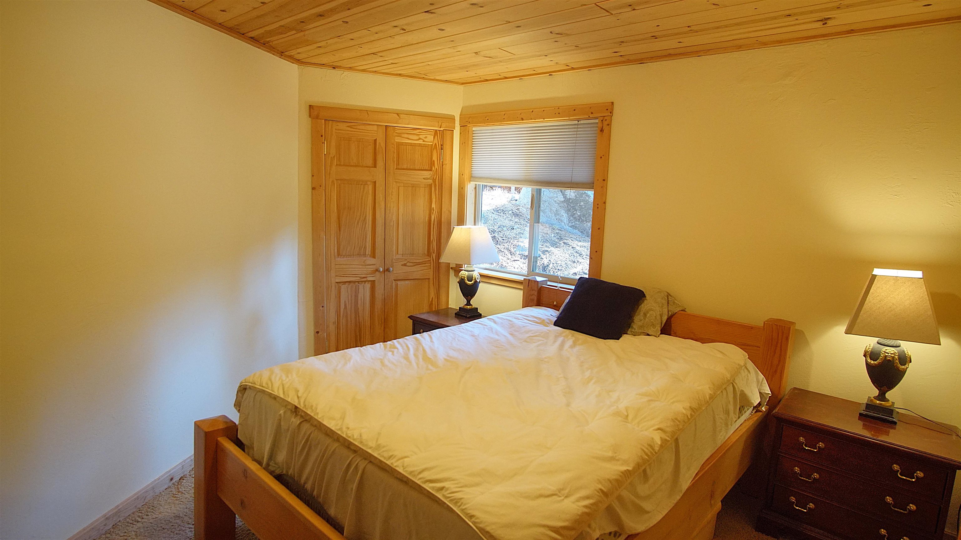 1557 Alpine Meadows Road Alpine Meadows, CA 96146 - Photo 25 of 28 a bedroom with a bed and wooden floor