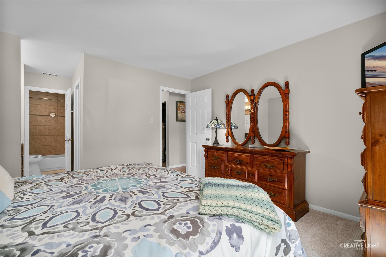1703 Lakecliffe Drive, Unit D Wheaton, IL 60189 - Photo 11 of 20 a bed sitting in a bedroom next to a window and a mirror