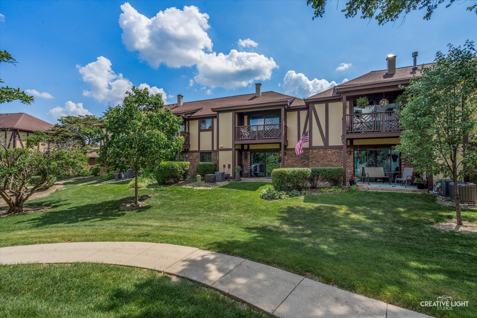 1703 Lakecliffe Drive, Unit D Wheaton, IL 60189 - Photo 16 of 20 a front view of a house with a garden