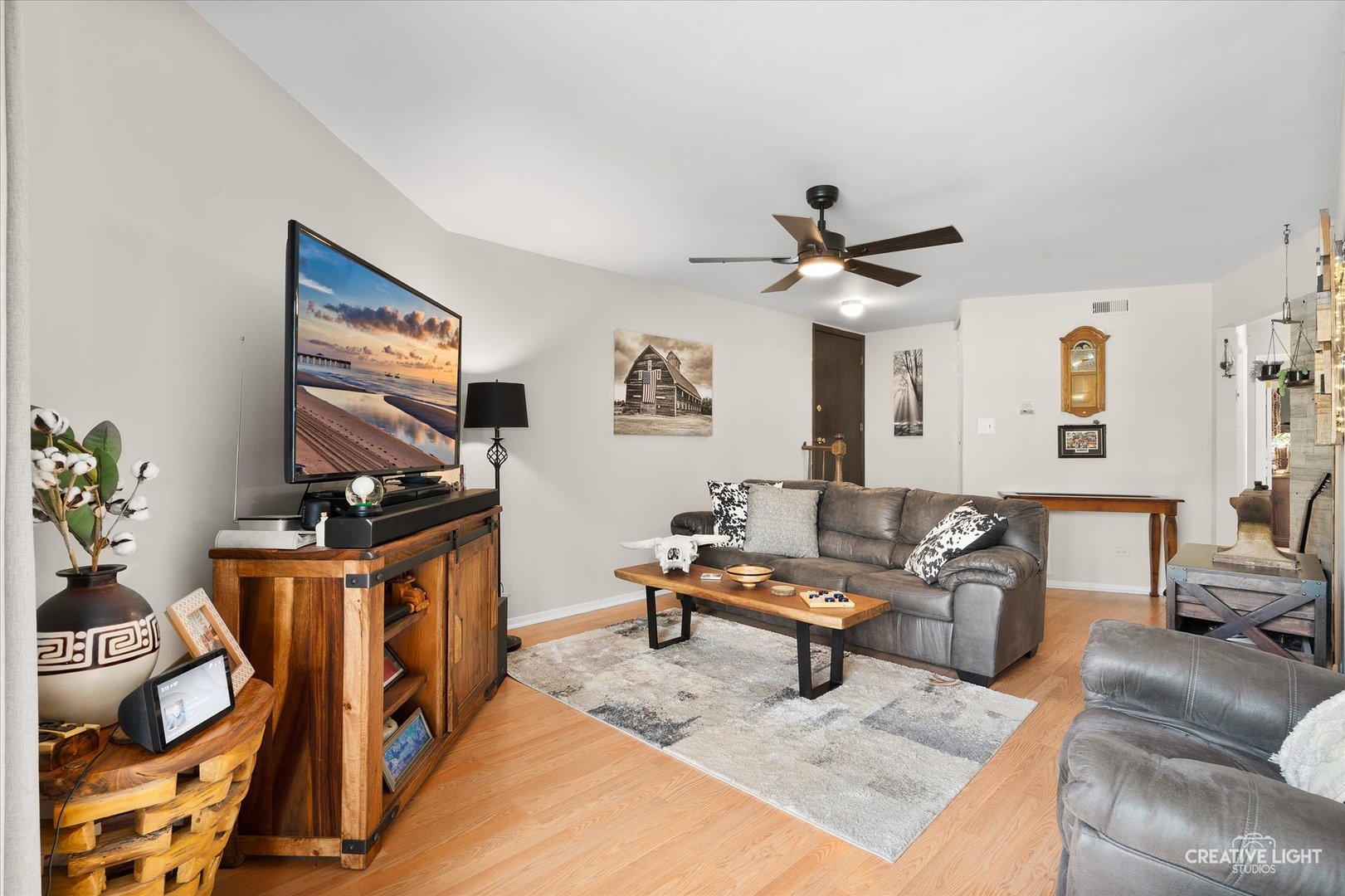 1703 Lakecliffe Drive, Unit D Wheaton, IL 60189 - Photo 5 of 20 a living room with furniture a ceiling fan and a rug