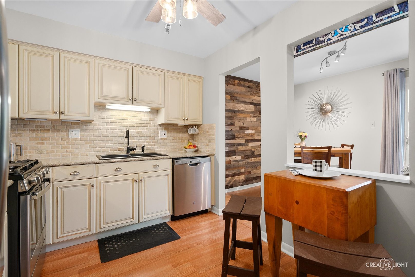 1703 Lakecliffe Drive, Unit D Wheaton, IL 60189 - Photo 9 of 20 a kitchen with stainless steel appliances granite countertop a sink stove and refrigerator