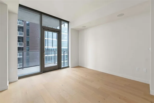 a view of balcony with floor to ceiling windows and wooden floor