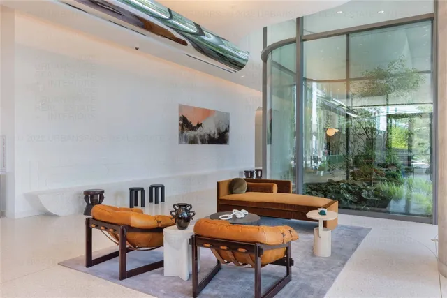 a living room with furniture and a floor to ceiling window