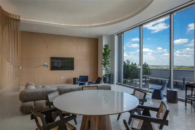 a living room with furniture and potted plant
