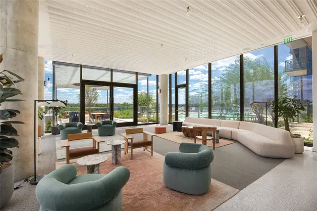 a view of a swimming pool and lounge chairs