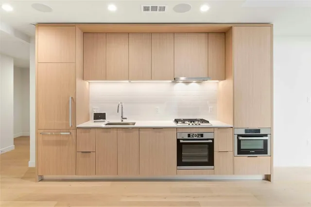 a kitchen with a stove and white cabinets