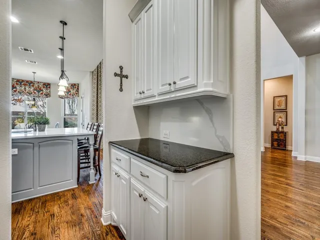 a kitchen with granite countertop a sink and cabinets