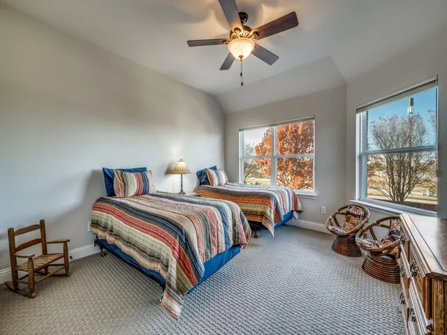 a bedroom with bed and a large window