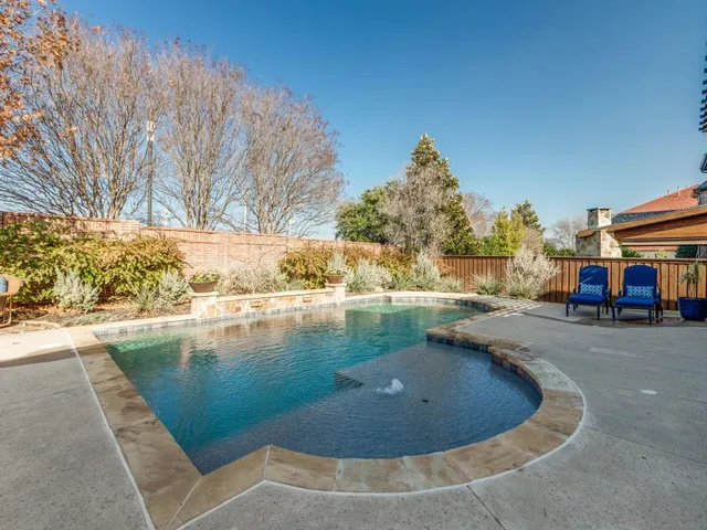 a view of a swimming pool with outdoor seating