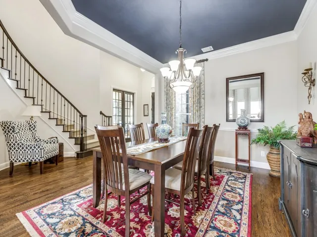 a view of a a dining room with furniture window and wooden floor
