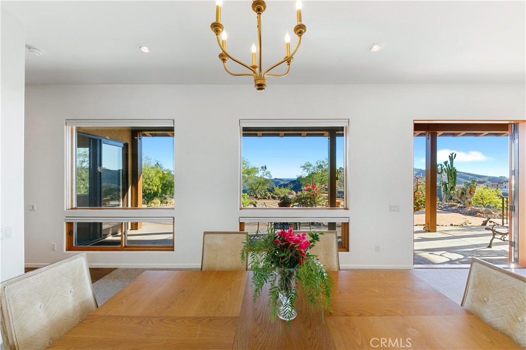 8400 Mipolomol Road Malibu, CA 90265 - Photo 14 of 58 a living room with furniture and a large window