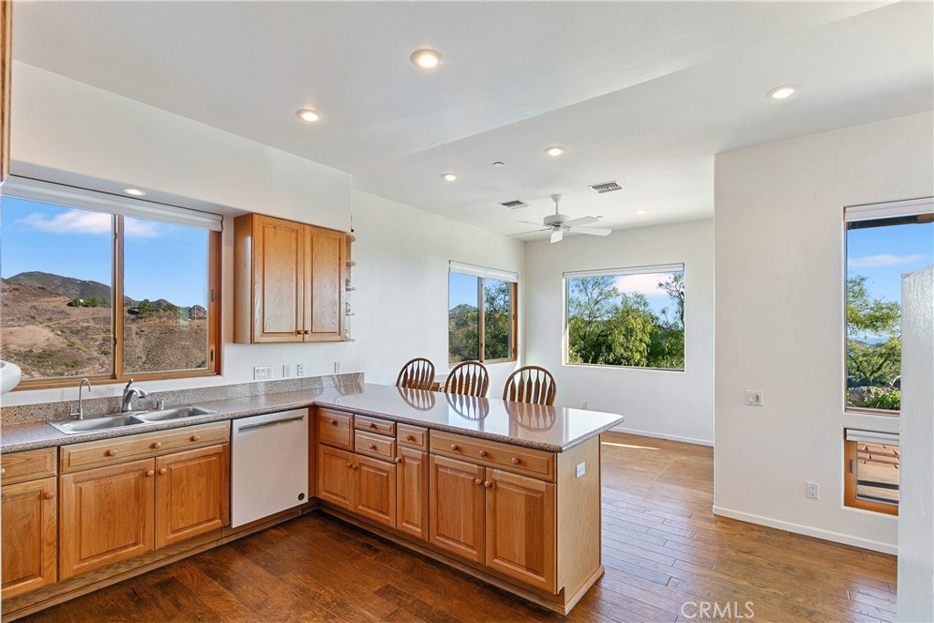 8400 Mipolomol Road Malibu, CA 90265 - Photo 17 of 58 a kitchen with sink a refrigerator and wooden floor