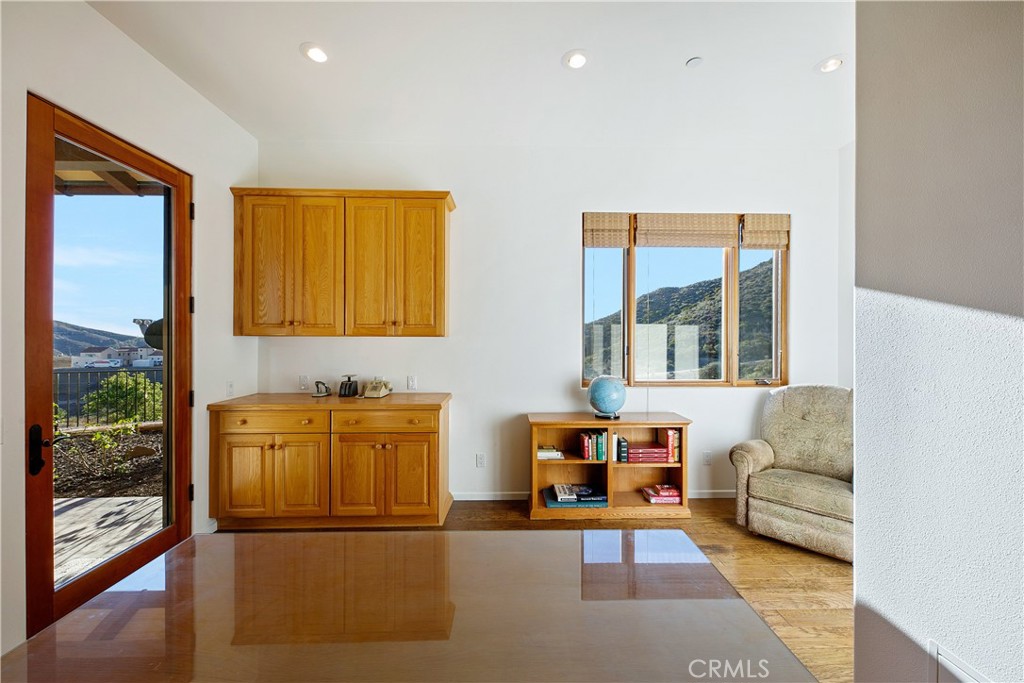8400 Mipolomol Road Malibu, CA 90265 - Photo 26 of 58 a living room with furniture and large windows