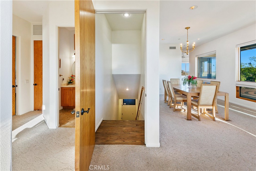 8400 Mipolomol Road Malibu, CA 90265 - Photo 39 of 58 a view of a dining room with furniture and a chandelier