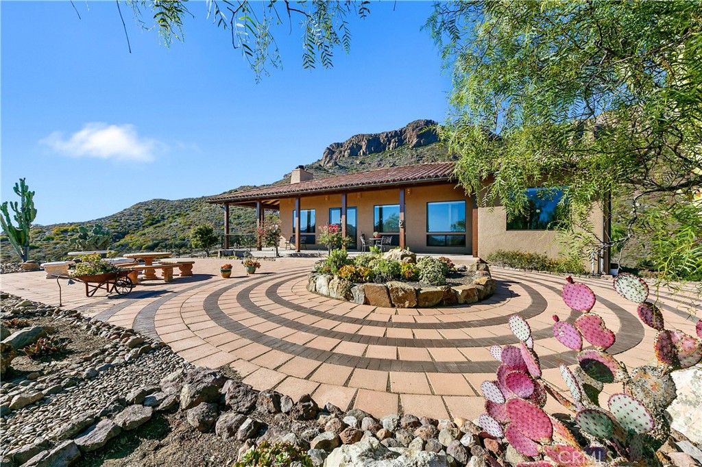 8400 Mipolomol Road Malibu, CA 90265 - Photo 4 of 58 a swimming pool with barbeque oven and outdoor seating