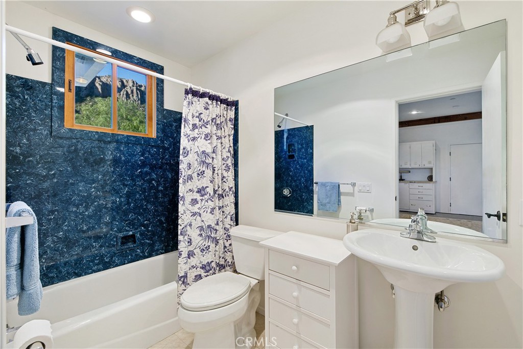 8400 Mipolomol Road Malibu, CA 90265 - Photo 44 of 58 a bathroom with a sink a toilet and a bathtub