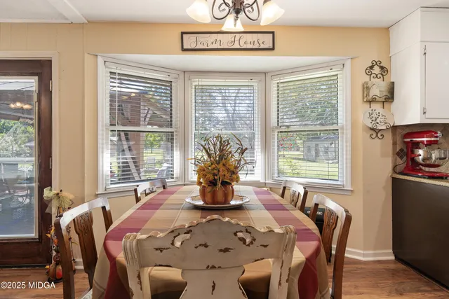 a living room with furniture a rug and a chandelier