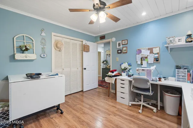 a bedroom with furniture and a flat screen tv