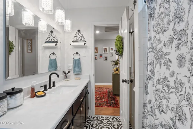 a hallway with furniture and a potted plant