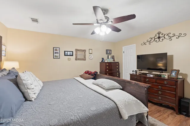 a view of a patio with table and chairs potted plants and a large tree
