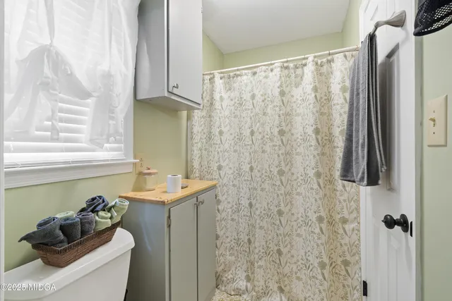 a view of a bench in the garden near a lake