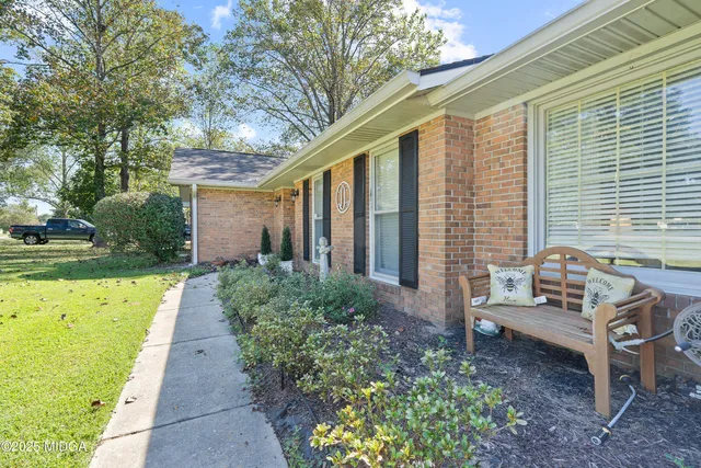 a living room with furniture fireplace and a window