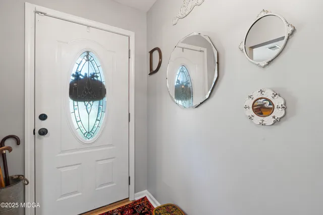 a view of a dining room with furniture and chandelier