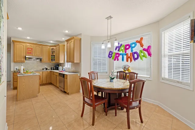 a kitchen with stainless steel appliances a sink counter space and a window