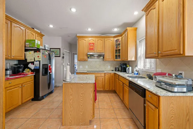 a kitchen with stainless steel appliances granite countertop a sink stove and refrigerator