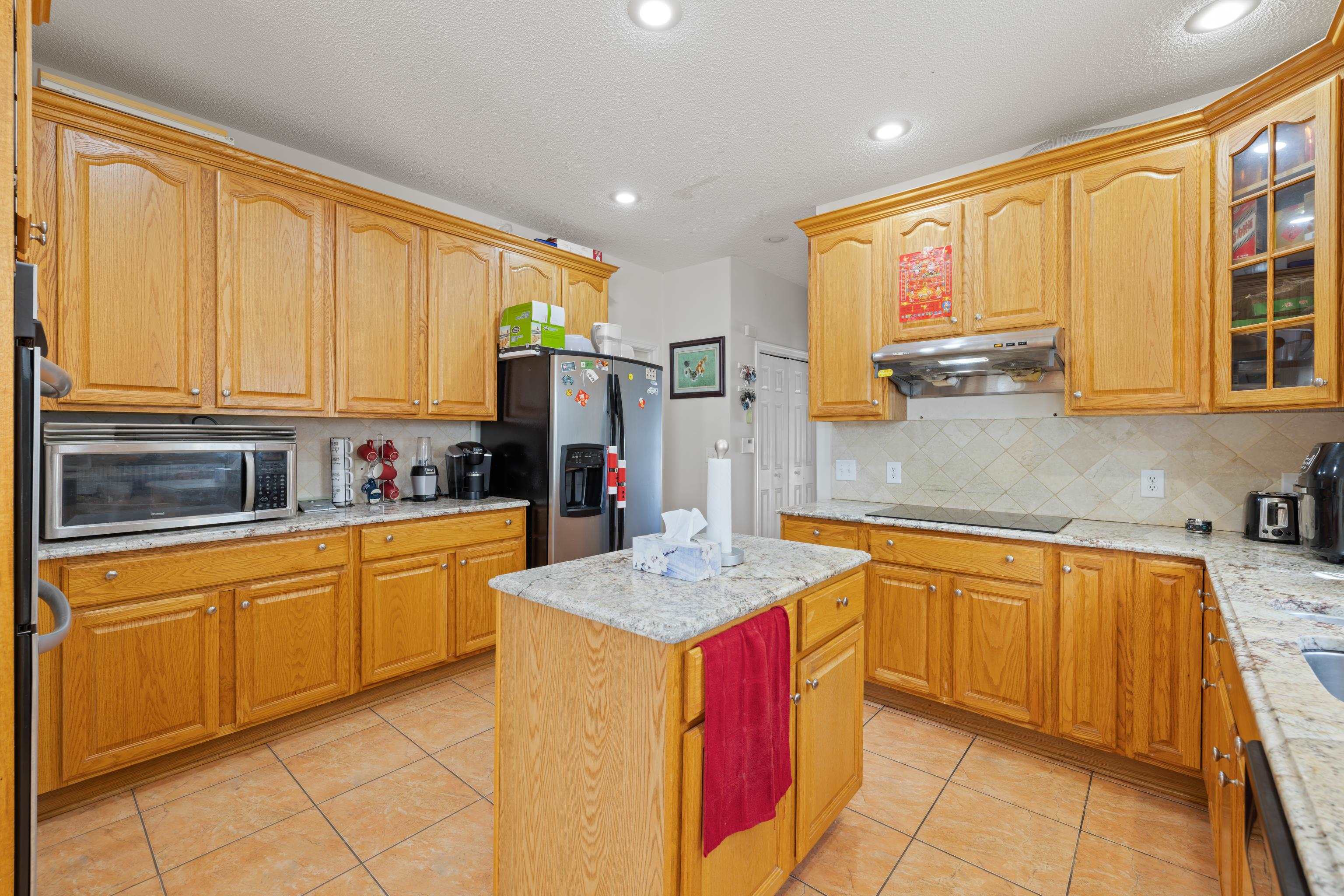 635 Long Meadow Road Fishersville, VA 22939 - Photo 16 of 63 a kitchen with stainless steel appliances granite countertop a sink stove and refrigerator