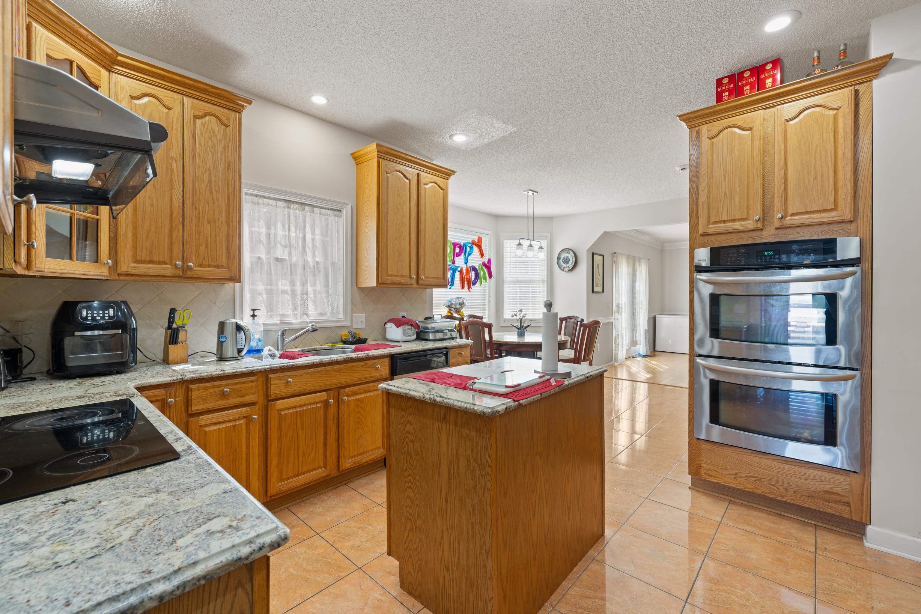 635 Long Meadow Road Fishersville, VA 22939 - Photo 17 of 63 a kitchen with stainless steel appliances granite countertop a sink stove and refrigerator