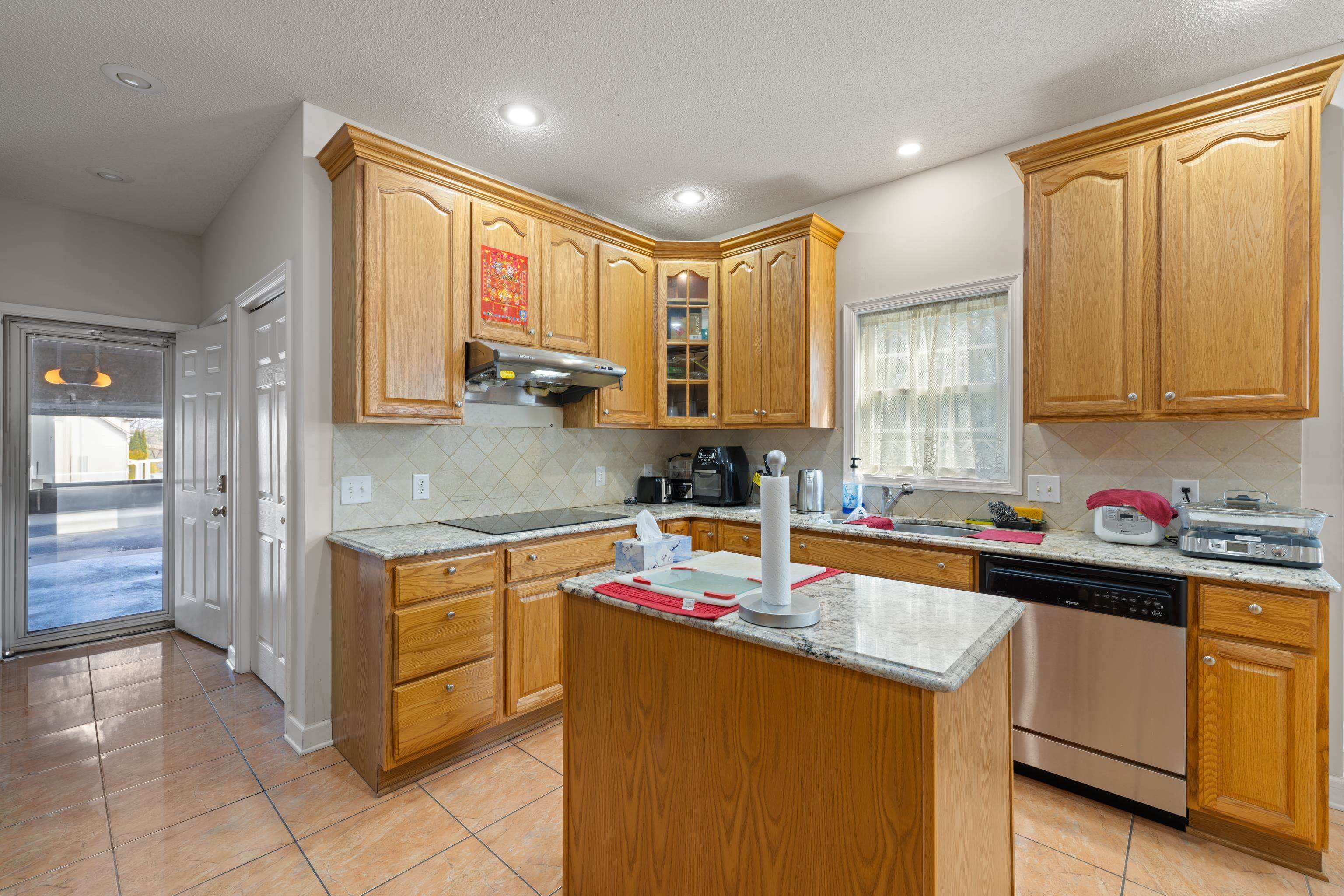 635 Long Meadow Road Fishersville, VA 22939 - Photo 24 of 63 a kitchen with kitchen island granite countertop a sink cabinets and window