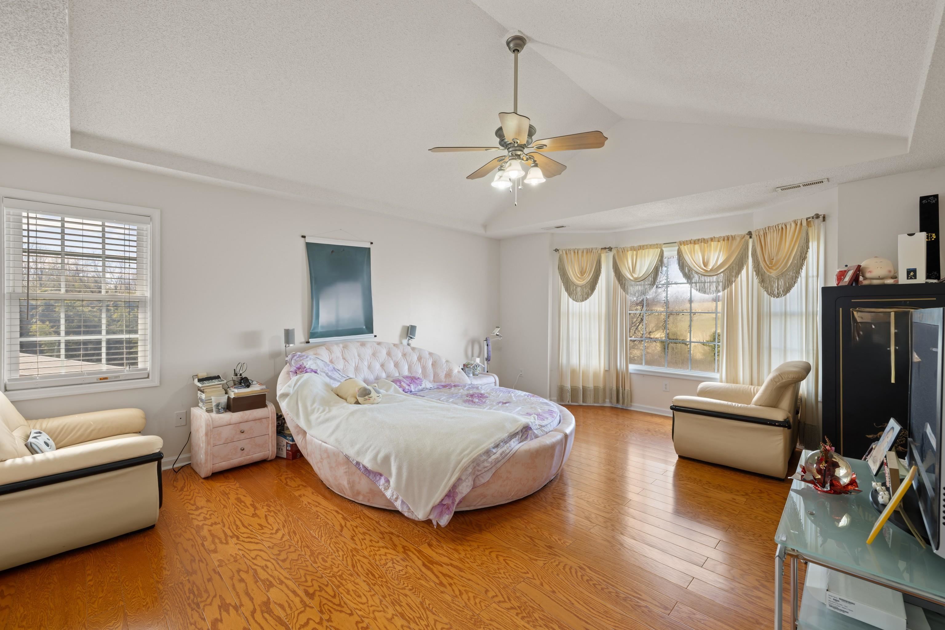 635 Long Meadow Road Fishersville, VA 22939 - Photo 25 of 63 a spacious bedroom with a bed and a couch
