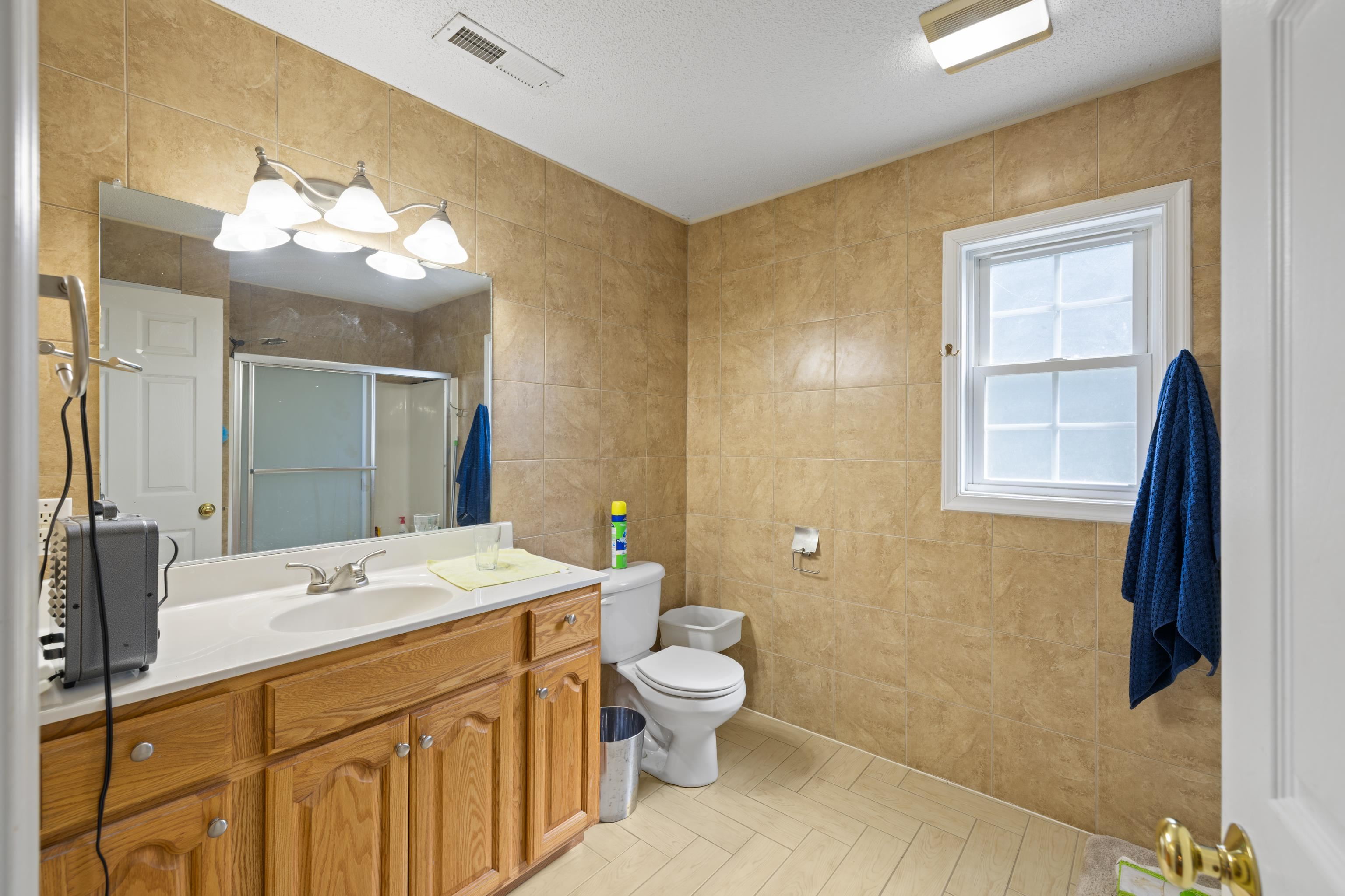 635 Long Meadow Road Fishersville, VA 22939 - Photo 36 of 63 a spacious bathroom with a double vanity sink toilet and a mirror