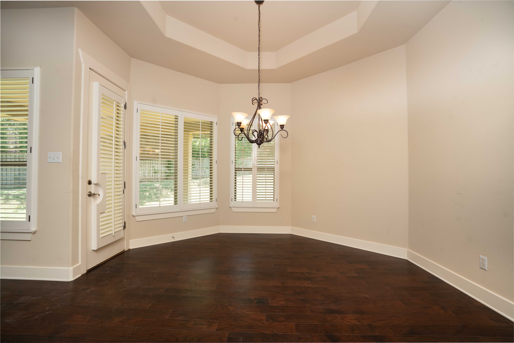210 Rivulet Lane Austin, TX 78738 - Photo 11 of 28 A striking chandelier illuminates this spacious room with elegant hardwood flooring and abundant natural light.