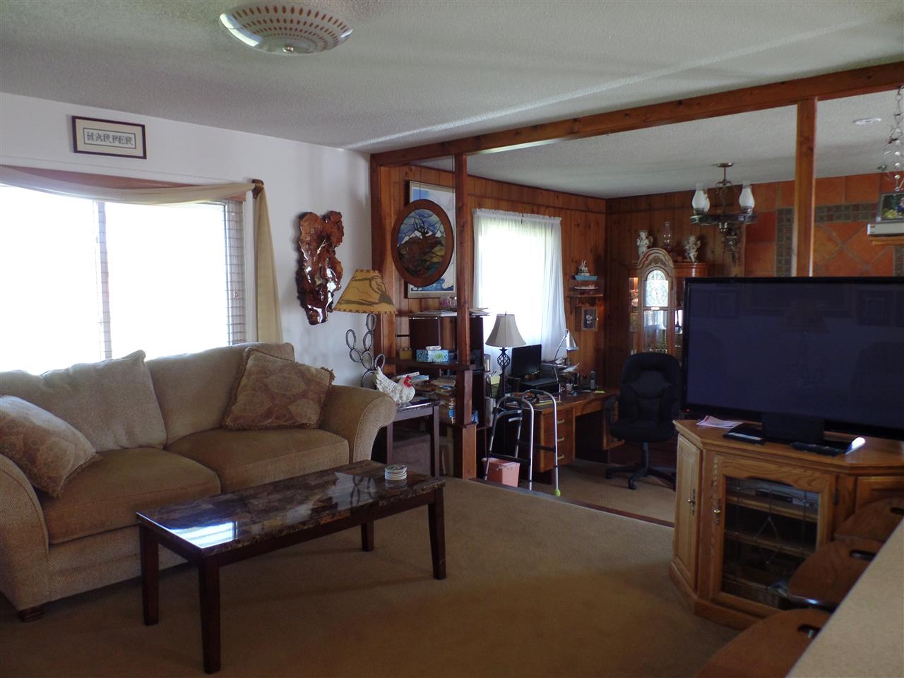 1349 Q Road Loma, CO 81524 - Photo 17 of 32 a living room with furniture a dining table and a fireplace