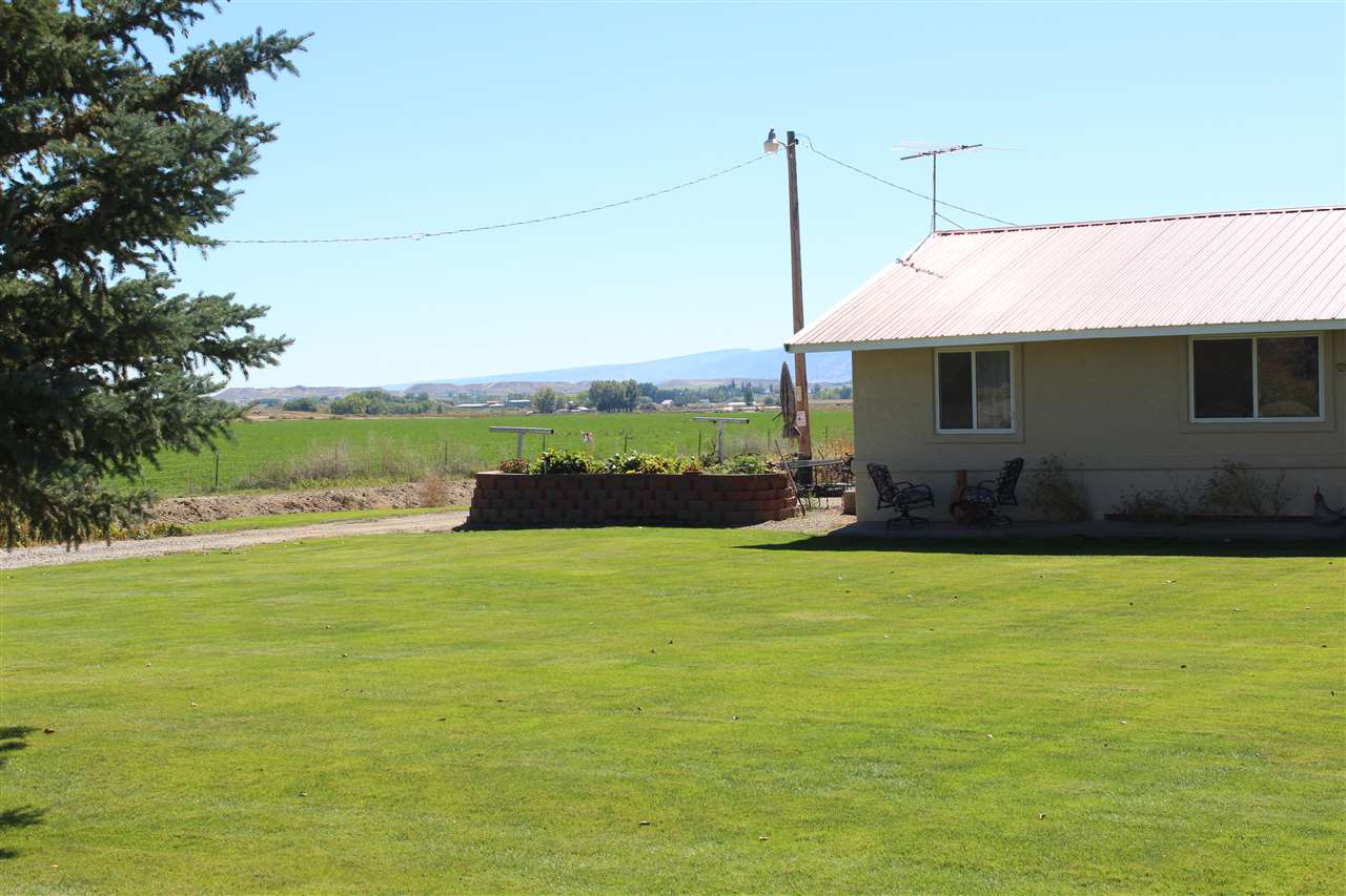 1349 Q Road Loma, CO 81524 - Photo 9 of 32 a front view of a house with a yard