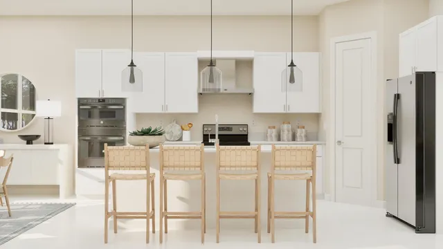 a white kitchen with stainless steel appliances granite countertop a refrigerator a stove a sink a dining table and chairs with wooden floor