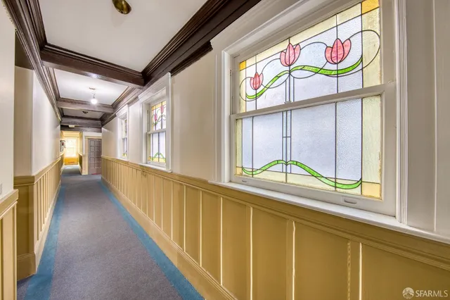 a view of a dining room with furniture and a window