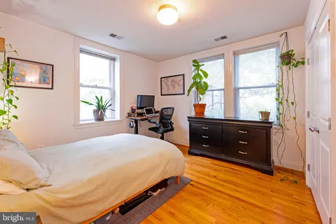 a bedroom with a bed and a tv on table