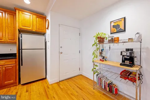 a kitchen with stainless steel appliances granite countertop a refrigerator a stove a sink and a microwave