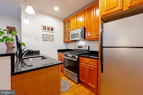 a kitchen with stainless steel appliances granite countertop a stove and a microwave
