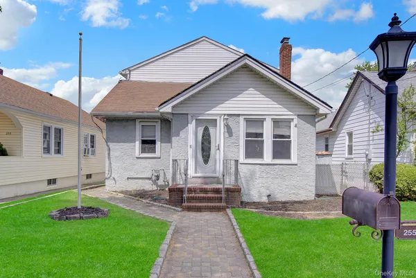 a front view of a house with a garden and yard