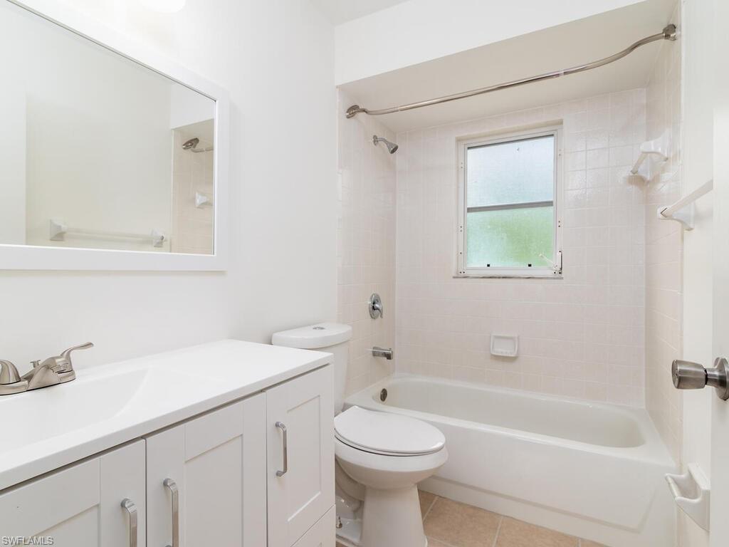 17432 Lee Road Fort Myers, FL 33967 - Photo 11 of 24 a bathroom with a sink a toilet and shower