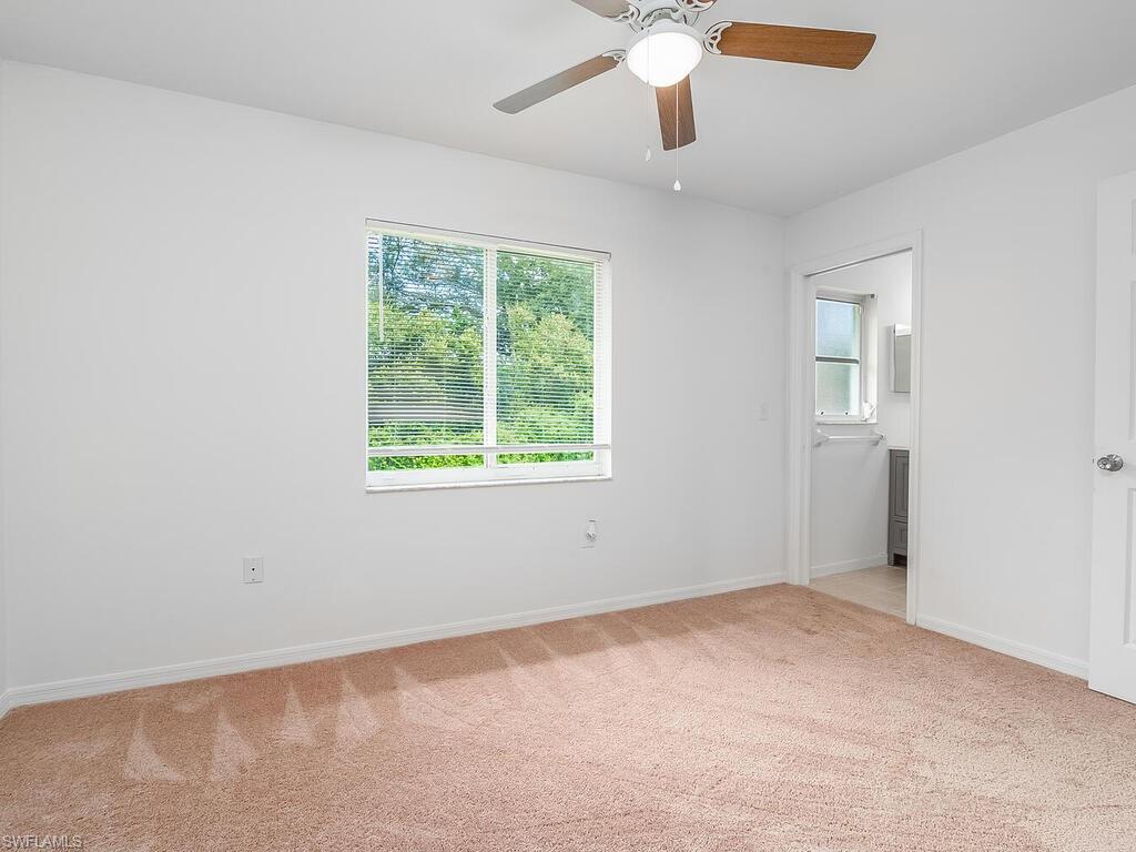 17432 Lee Road Fort Myers, FL 33967 - Photo 15 of 24 an empty room with windows and fan