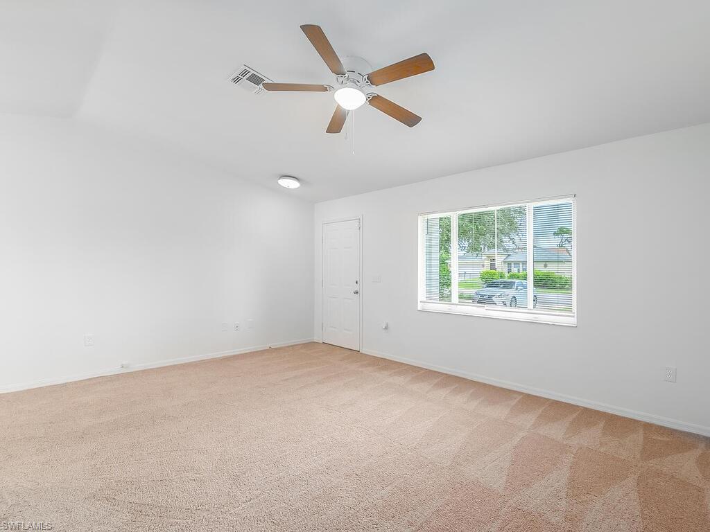 17432 Lee Road Fort Myers, FL 33967 - Photo 17 of 24 an empty room with ceiling fan and windows