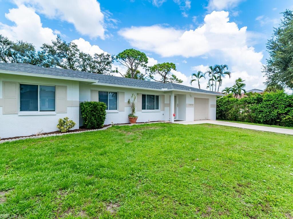 17432 Lee Road Fort Myers, FL 33967 - Photo 2 of 24 a view of a house with a yard and potted plants